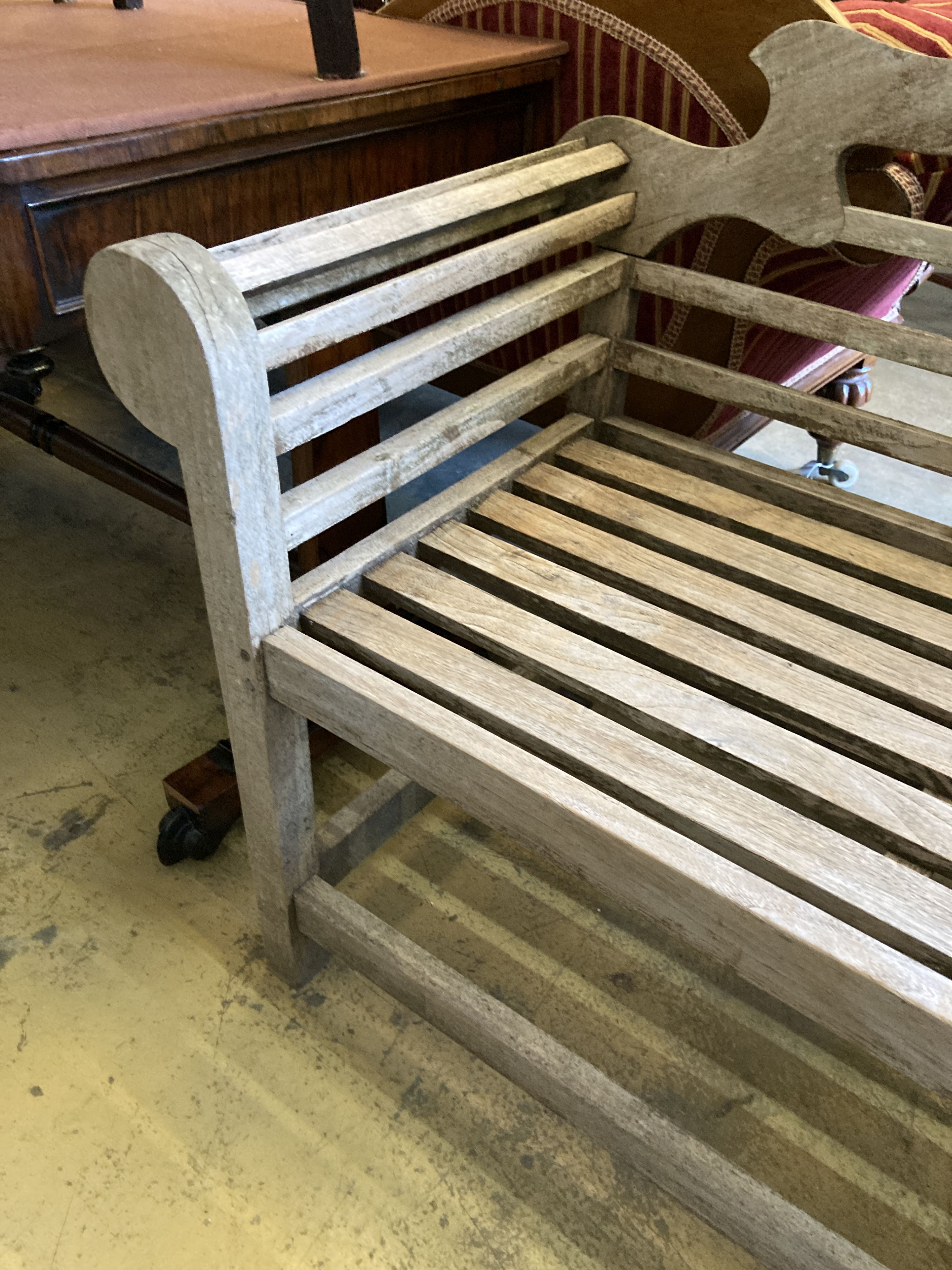 A Lutyens style weathered teak garden bench, length 166cm, depth 58cm, height 105cm